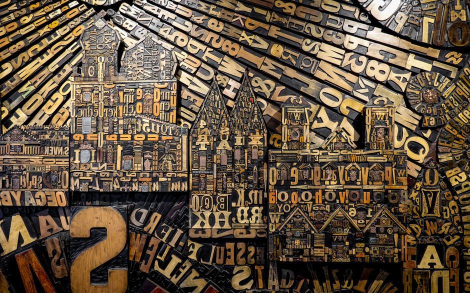 Complex assemblage of wooden letters creating a visual art piece. Perfect for design inspiration.
